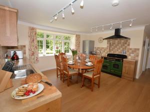 a kitchen with a table with a plate of food on it at 3 Bed in Wrexham oc-39974 in Overton