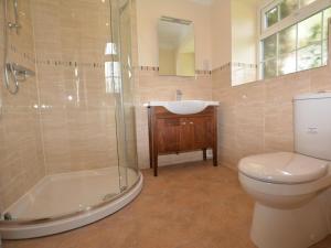 a bathroom with a toilet and a sink and a shower at 3 Bed in Wrexham oc-39974 in Overton