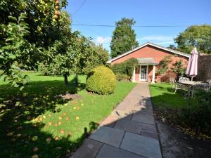 a house with a garden and a walkway at 3 Bed in Wrexham oc-39974 in Overton +5 photos