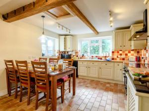 a kitchen with a wooden table and chairs at 3 Bed in Kings Lynn oc-43950 in Docking