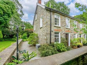 a brick house with a street light in front of it at 2 Bed in Llandysul oc-85444 in Felindre