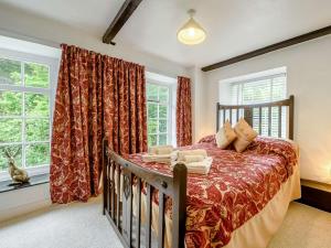 a bedroom with a bed and two windows at 2 Bed in Llandysul oc-85444 in Felindre