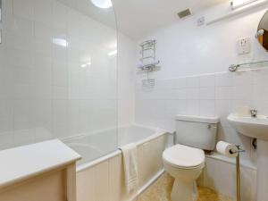 a white bathroom with a toilet and a sink at 2 Bed in Llandysul oc-85444 in Felindre +17 photos