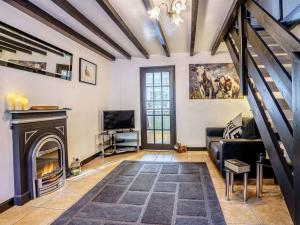 a living room with a couch and a fireplace at 2 Bed in Llandysul oc-79199 in Felindre