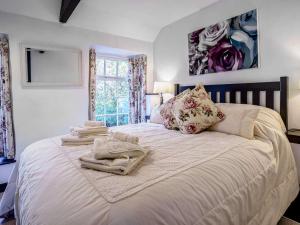 a bedroom with a large bed with towels on it at 2 Bed in Llandysul oc-79199 in Felindre
