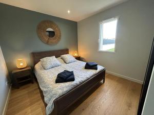a bedroom with a bed with two pillows on it at Gîte Le 10 in Neuville-du-Poitou +20 photos