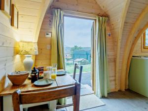 a table in a tiny house with a large window at 1 Bed in Shrewsbury oc-93395 in Leighton