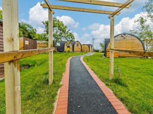 a path in a field with buildings in the background at 1 Bed in Shrewsbury oc-93395 in Leighton