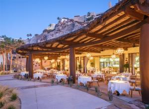 an outdoor dining area with tables and chairs at Waldorf Astoria Los Cabos Pedregal in Cabo San Lucas