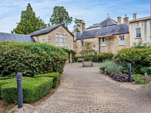 a stone house with a brick pathway in front of it at 1 Bed in Cirencester oc-90128 in Cirencester