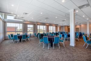 a conference room with tables and blue chairs at Hampton Inn & Suites Edmonton St. Albert, Ab in Edmonton +44 photos