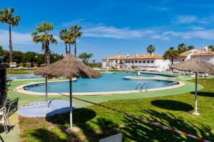 a swimming pool with palm trees and a resort at Lago Jardin 69 in Los Altos