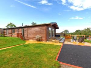a log cabin with a patio and a yard at 4 Bed in Shrewsbury oc-93398 in Leighton