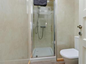 a shower stall in a bathroom with a toilet at 4 Bed in Shrewsbury oc-93398 in Leighton +11 photos