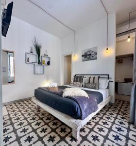 a bedroom with a large bed in a room at Nap25guesthouse in Polignano a Mare