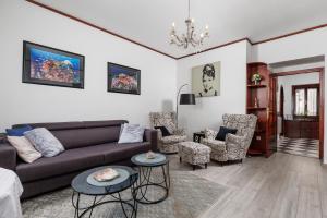 a living room with a couch and chairs at Apartment Audrey - free parking by Irundo in Rijeka