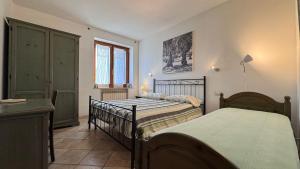 a bedroom with two beds and a window at Agriturismo La Facenda in Albinia +104 photos