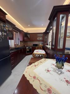 a kitchen with a table with a vase on it at Azure Horizon in Çukë