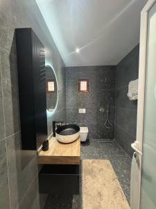 a bathroom with a sink and a toilet at Azure Horizon in Çukë