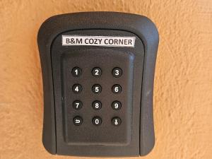 a black remote control with the words benonym cozy corner at B&M Cozy Corner in Igoumenitsa