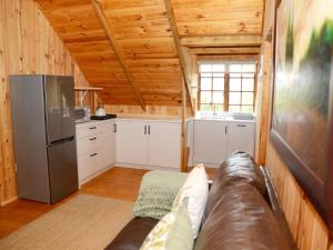 a living room with a couch and a kitchen at Farside Macadamias in Riversdale