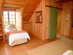 a bedroom with a bed and a green door at Farside Macadamias in Riversdale