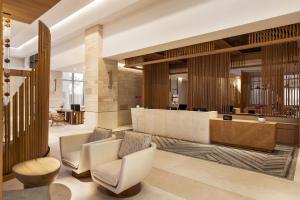 a lobby with chairs and a reception desk at Hilton Cancun, an All-Inclusive Resort in Cancún