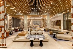 a lobby with couches and tables in a building at Hilton Cancun, an All-Inclusive Resort in Cancún +115 photos