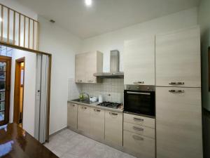 a kitchen with white cabinets and a stove at Chalet di città in Rome
