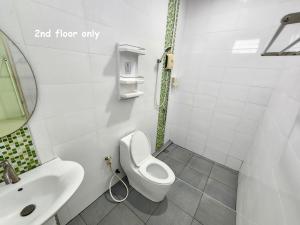 a white bathroom with a toilet and a sink at Vanilla Ville Resort in Khlong Thom +50 photos
