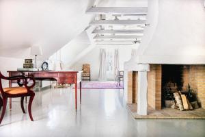 a living room with a fireplace and a desk at Karlaby kro in Karlaby