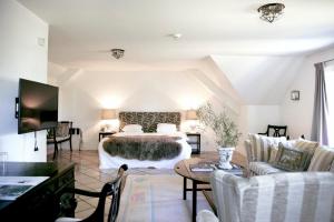 a bedroom with a bed and a living room at Karlaby kro in Karlaby