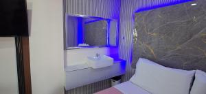 a bathroom with a sink and a mirror at PrimeRose Residences - Near Mactan-Cebu International Airport in Lapu Lapu City