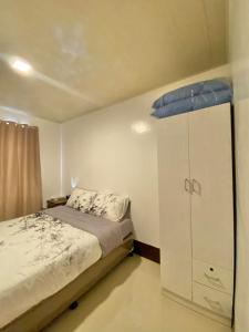 a bedroom with a bed and a blue object on the ceiling at ErrZ Homestay in Malaybalay in Malaybalay