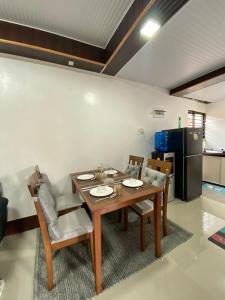 a dining room with a wooden table and chairs at ErrZ Homestay in Malaybalay in Malaybalay