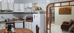 a kitchen with a white refrigerator and a table at Casa Térrea em Correntina in Correntina