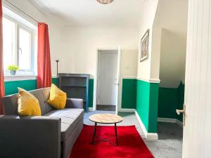 a living room with a couch and a table at New Hampton Units in Wolverhampton