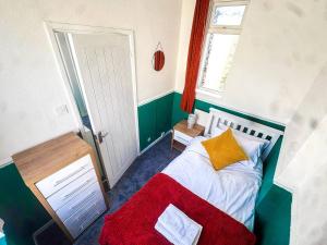 a small bedroom with a bed and a window at New Hampton Units in Wolverhampton