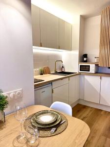 a kitchen with a table with a plate on it at FLOK horizon in Malbuisson
