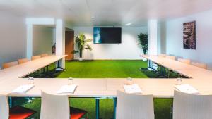 a conference room with tables and chairs and a screen at Hotel La Mandarine Saint Tropez in Saint-Tropez +238 photos