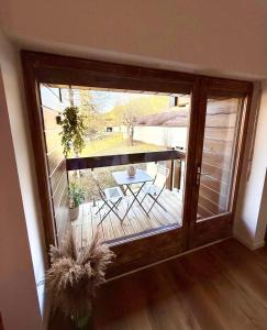 a sliding glass door with a table on a patio at FLOK horizon in Malbuisson +24 photos