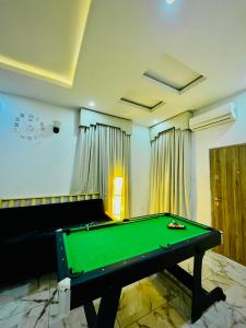 a pool table in a room with a green table at Polo Apartments Lekki in Lekki