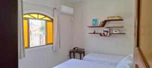 a room with a mirror and a bed and a window at Casa Térrea em Correntina in Correntina