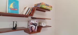 two wooden shelves with books on a wall at Casa Térrea em Correntina in Correntina