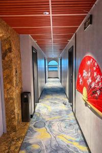 a hallway with a painting on the wall and a tile floor at Dragon King Hotel Nghệ An in Cửa Lô