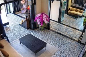 a lobby with a bench and flowers on the floor at Dragon King Hotel Nghệ An in Cửa Lô