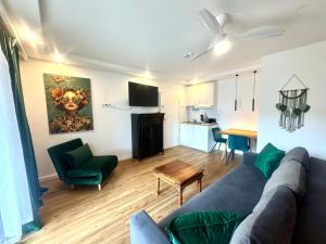 a living room with a blue couch and a table at VILLA ORCHARD Frankfurt - Trade Fair Airport in Kriftel