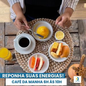 a table with plates of food and a cup of coffee at Belaris HOTEL EXECUTIVO - Próximo a Praia do Calhau in São Luís