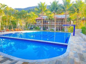 a swimming pool in front of a resort at Flat Duplex Premium - Maresias - 150m da Praia Piscina, Wi-Fi e Garagem in São Sebastião