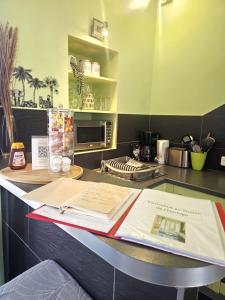 a kitchen counter with a book on a table at STUDIO DE L'HORLOGE in Dinan +4 photos